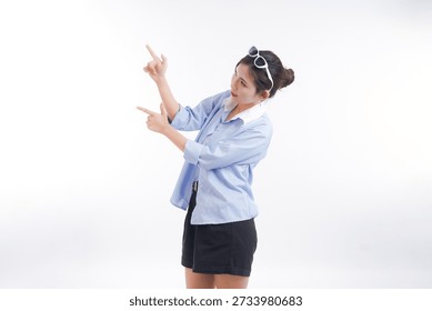 Engaging Expression: A captivating individual uses her hand to gesture at something unseen with a cheerful and engaging countenance, against a simple backdrop.