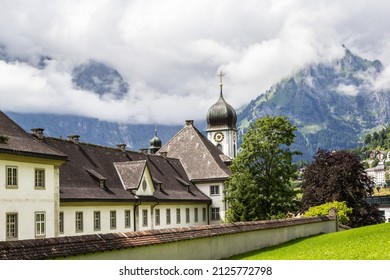 Engelberg Abbey, a Benedictine monastery wiht Alps mountains on the background