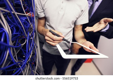 Engeneer And Business Man In Network Server Room With Digital Tablet