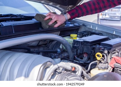 engine of a car, car mechanic cleaning engine