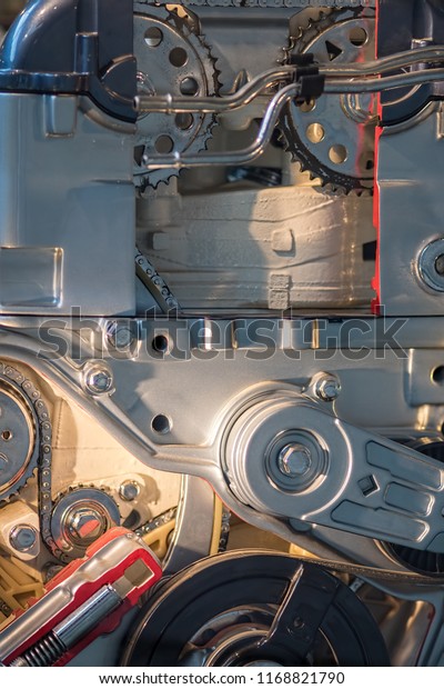 Engine components close-up. Mechanical\
engineering science and technology background image. Cogs and chain\
on aluminium block. Parts layout in close\
up.