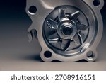 Engine cooling pump, engine coolant pump for a passenger car on a black gradient background. Selective focus