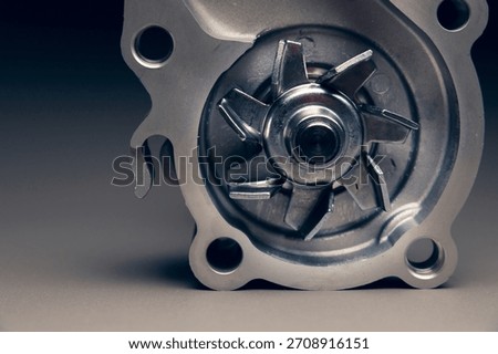 Engine cooling pump, engine coolant pump for a passenger car on a black gradient background. Selective focus
