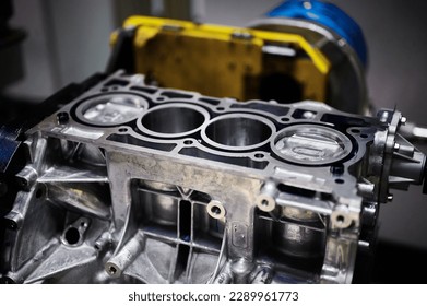 Engine cylinder block with installed pistons in workshop