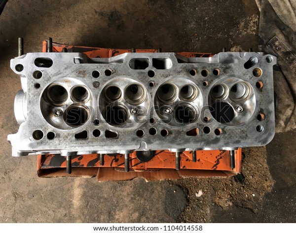Engine cylinder bore and remove the cylinder head
and piston for repair, Maintenance routine job in garage and repair
the engine, industry concept which expert replace new spare part of
the engine.