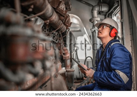 Engine engineer inspecting large machines in factory,Railway engine maintenance technician,engine repair mechanical manager