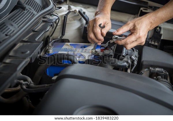 Engine
engineer is replacing  car battery because car battery is depleted.
concept car maintenance And the cost of car
care.