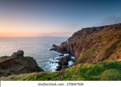Engine houses perched on the edge of steep rugged cliffs at Botallack near Land's End in Cornwall