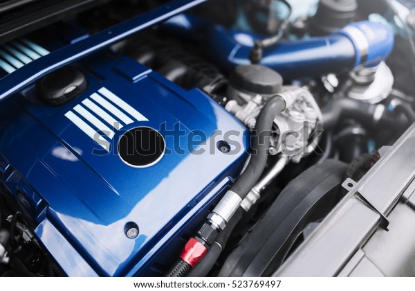 Engine motor of blue car\
under hood