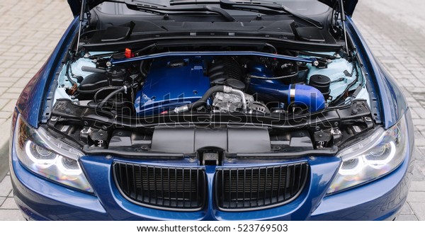 Engine motor of blue car\
under hood