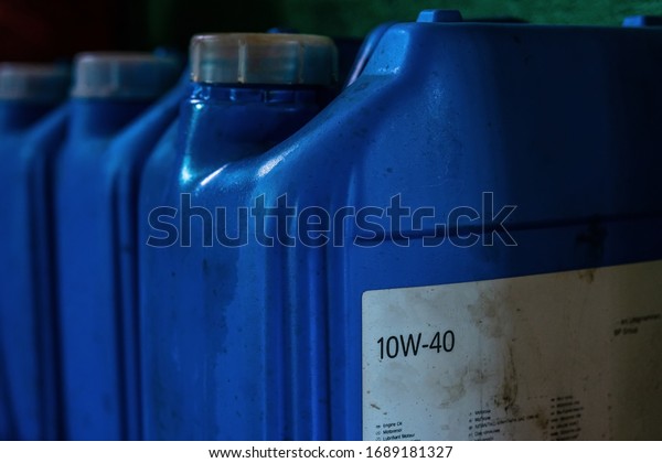 Engine\
oil in canisters of blue color at a car\
service