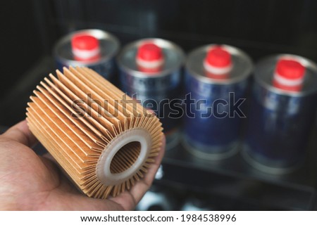Engine oil filter on auto mechanic hand.
