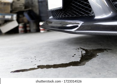 Engine Oil Stains Of Car Leak Under The Car When The Car Is Park In The Garage Service Floor Photo Concept For Check And Maintenance