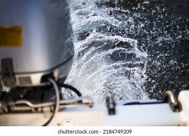 Engine On A Boat Cutting Through The Splashing River Water.