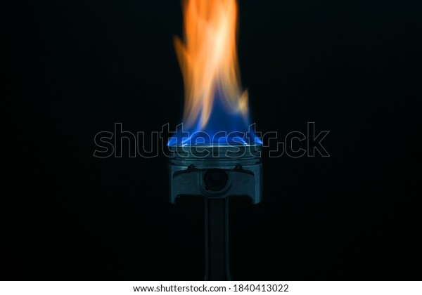 engine piston on fire\
on dark background