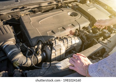 Engine problem. Driver man near open hood vehicle broken down on road. Auto motor car problem concept - Powered by Shutterstock