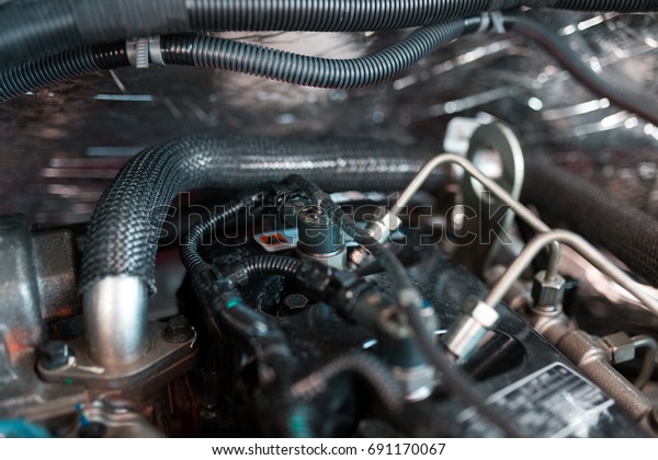 Engine repair. Checking of a car performance in
car-care service.
