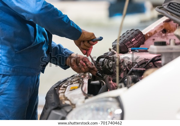 Engine repair. Checking of a car performance in\
car-care service.