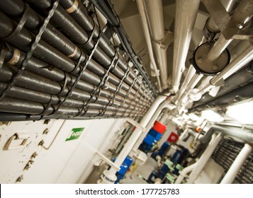 Engine Room Spaces on a modern vessel - engineering interior including pipes, cables, pumps