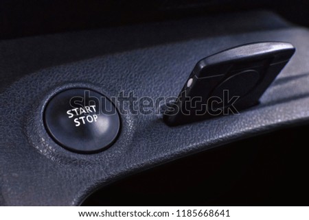 engine start button and key card on the auto panel. closeup