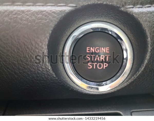 Engine start button on dash board or console of\
Modern Car
