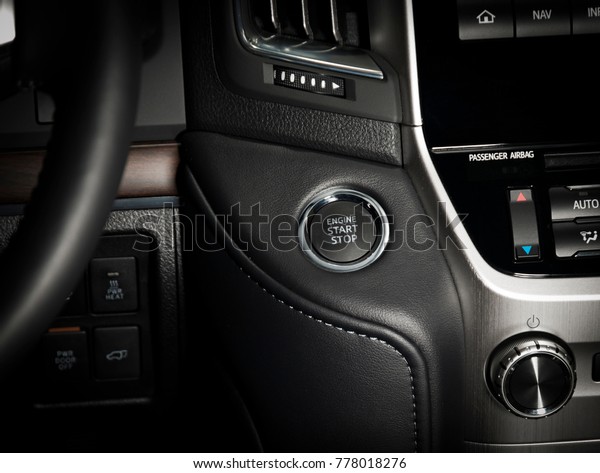 Engine\
start stop button in a modern luxury car\
interior