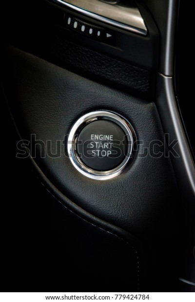 Engine\
start stop button in a modern luxury car\
interior