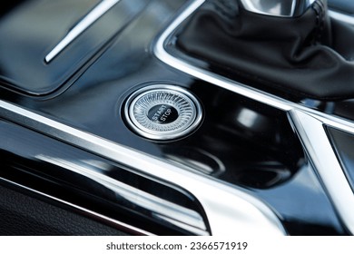 Engine Start Stop button on modern luxury car. black glossy design dashboard