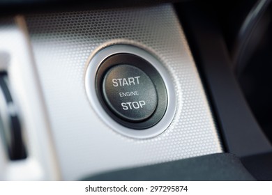 Engine start and stop button on electric hybrid car dashboard