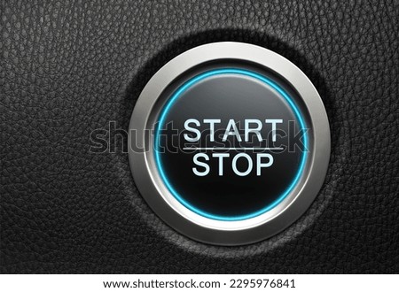 Engine Start Stop button on modern car. Black leather dashboard copy space