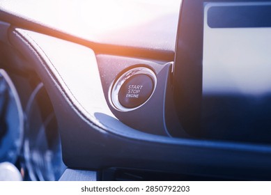 Engine start stop push button in modern car interior. Dashboard control and blank infotainment screen. Keyless ignition system. Automotive technology and modern driving background.