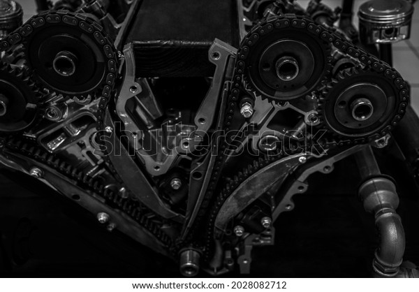 Engine timing mechanism. Car timing\
chain in cutaway engine. internal combustion\
engine