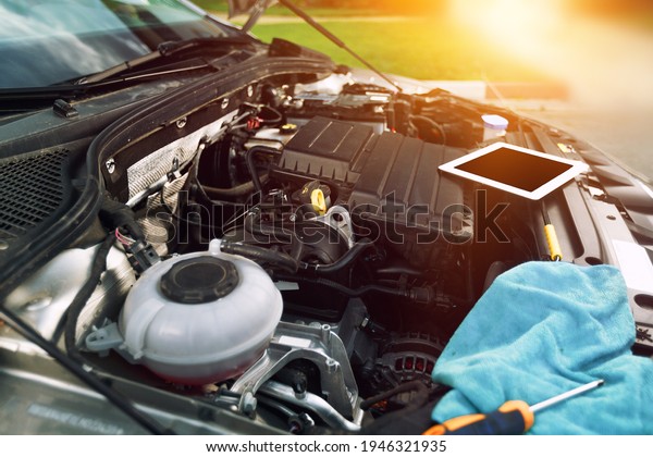 The engine a vehicle car hood for safety inspection\
test with repair tools