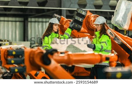 Engineer analyze blueprint in robotic facility to monitor carbon footprint and optimize emissions reduction. Developing sustainable manufacturing, energy efficiency, eco friendly industrial processes