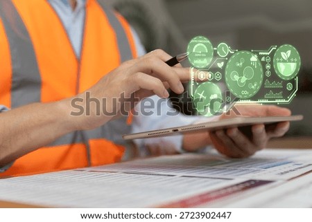 Engineer analyzing zero emission and carbon neutral data on digital interface using tablet. Sustainability technology, ESG concept, green energy, environmental analytics, and modern industrial management.