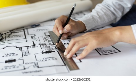 Engineer and Architect concept, Man uses a ruler to measure the floor plan on the blueprint, Building architecture design work, Construction design project under environmental conservation conditions. - Shutterstock ID 2022620231