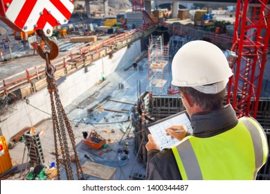 engineer architect Foreman on construction site with tablet computer - Shutterstock ID 1400344487