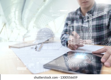 Engineer or Architect looking and touching interface with building design reality virtual technology on computer tablet at modern office on site . Building automation digital wireless control concept - Powered by Shutterstock