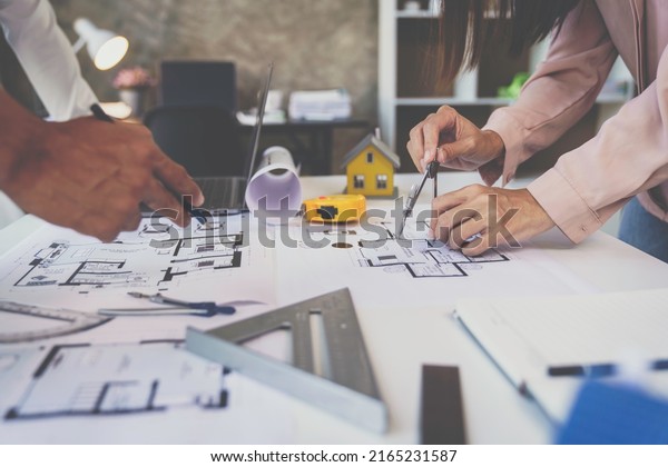 Engineer or architect meeting for project working with\
partner and engineering tools on model building and blueprint in\
working site, Construction, contract between two companies\
structure concept 