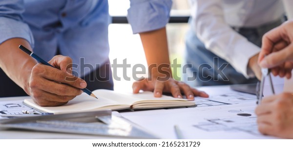 Engineer or architect meeting for project working with\
partner and engineering tools on model building and blueprint in\
working site, Construction, contract between two companies\
structure concept 