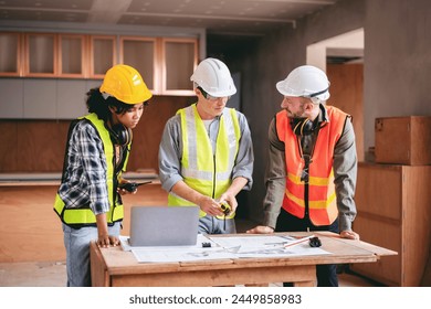 Engineer or architect team collaboration working in site discussing on blueprint building structure paperwork meeting for real estate project cooperation with partner and engineering equipment tools.