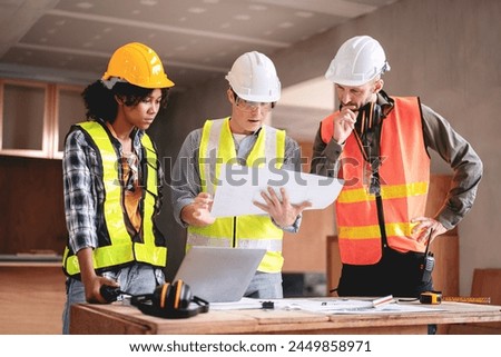 Engineer or architect team collaboration working in site discussing on blueprint building structure paperwork meeting for real estate project cooperation with partner and engineering equipment tools.