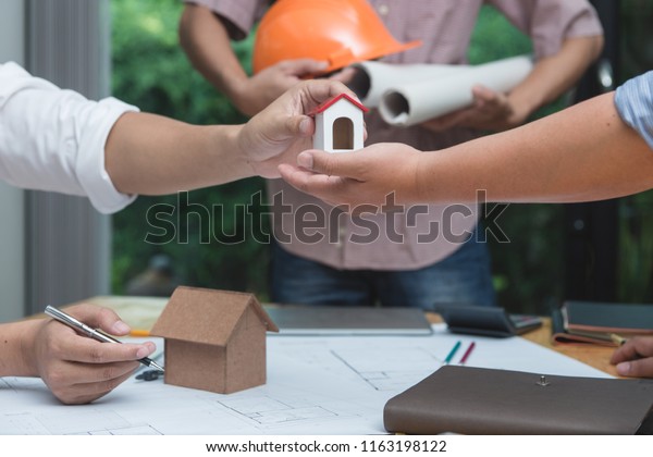 Engineer and architect\
team of real estate agency and company presidents discussing or\
analyzing to build a housing estate project. Concept of constuction\
contract and deal.