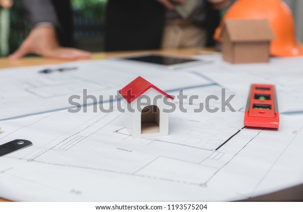 Engineer and architect\
team of real estate agency and company presidents discussing or\
analyzing to build a housing estate project. Concept of constuction\
contract and deal.
