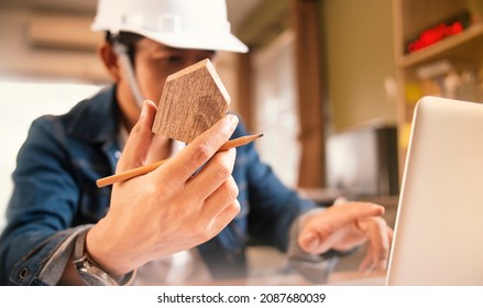 Engineer Or Architect Using The Wooden Home Model For Beginning Construction Development