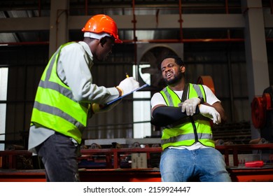 Engineer With An Arm Injury. Accident Concept. Safety. Male African American Worker Injured Arm Wearing A Cast. Friendship And Compassion For Workers. Injuries While Working In A Factory