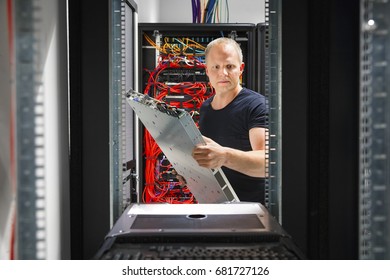 IT Engineer Arranging Server At Datacenter