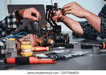 Engineer Asian Students Assembling Robotics Kits. Learning Mechanical Control, Robotics combines computer, electrical, mechanical, and sensing. Empowering Engineers and Development Concept.