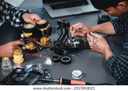 Engineer Asian Students Assembling Robotics Kits. Learning Mechanical Control, Robotics combines computer, electrical, mechanical, and sensing. Empowering Engineers and Development Concept.