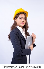 Engineer Asian Woman Wearing Black Suit And Yellow Safety Helmet Holding Laptop Computer Standing, Isolated On Gray Background.